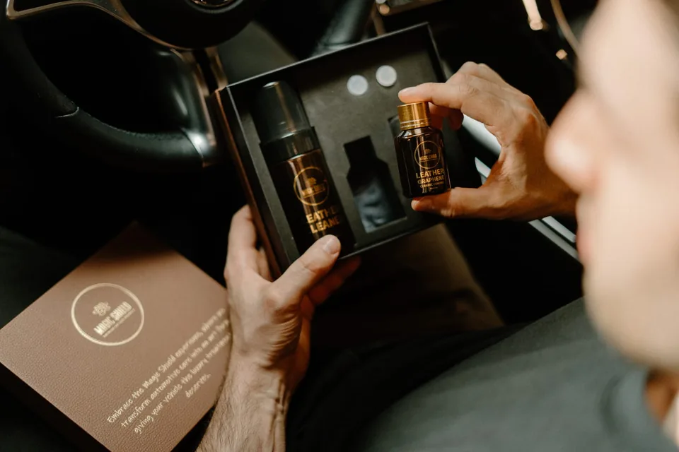 Open Magic Shield Leather Kit with the cleaner and coating bottle inside a car