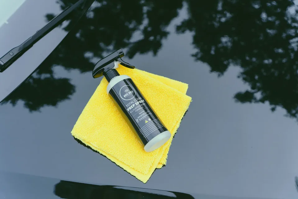 Magic Shield Prep Spray and clean microfiber towels ready beside a vehicle